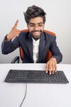 indian-man-glasses-working-computer-his-hands-hover-keyboard-while-typing-isolated-white-backg...jpg
