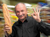 happy-senior-man-holding-fresh-baguette-supermarket-42481373.jpg