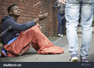 stock-photo-homeless-teenage-boy-begging-for-money-on-the-street-216280600.jpg