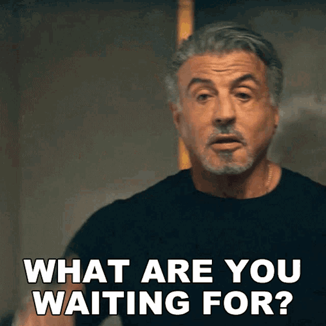 a man in a black shirt is asking what are you waiting for
