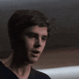 a close up of a man 's face in a dark room .