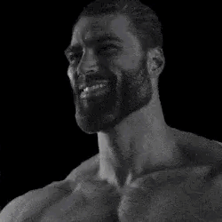 a black and white photo of a bearded man smiling .