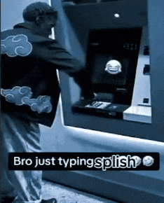 a man wearing a jacket with clouds on the back is typing on an atm machine