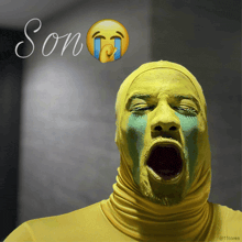 a man in a yellow mask is crying and the word son is written above him
