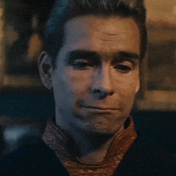 a close up of a man 's face making a funny face .