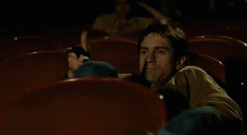 taxi-driver-travis-bickle-watching-movie-0af686rhnm496o72.gif