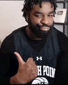 a man with a beard wearing a jersey that says h point