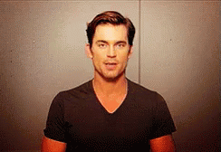 a man in a black shirt is making a face .