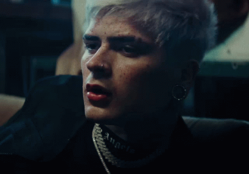 a close up of a person 's face with the word angels on his neck