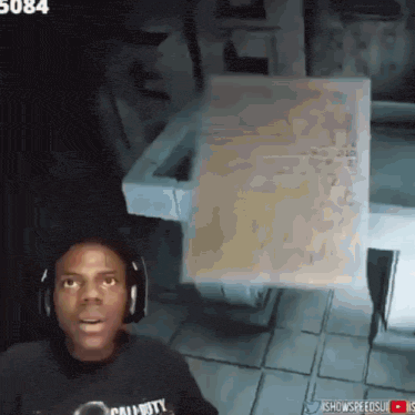 a man wearing headphones and a call of duty shirt stands in front of a sink