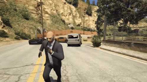 a man in a suit and tie is running down the road
