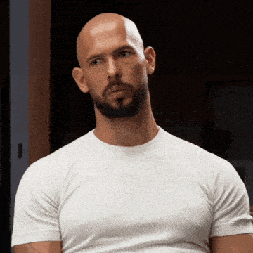 a bald man with a beard wearing a white t-shirt