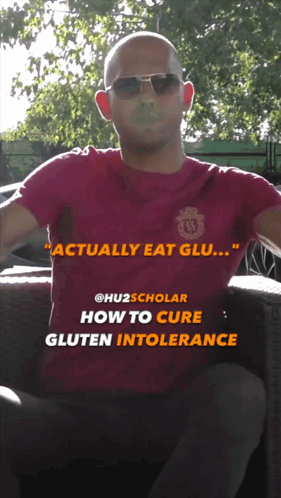 a man wearing sunglasses and a red shirt with the words  actually eat glu  on it