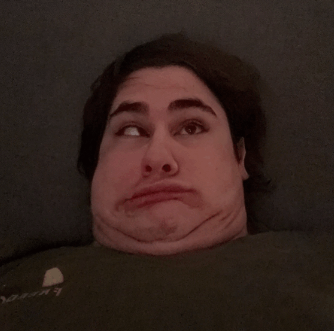 a man is making a funny face with his eyes closed and a shirt that says abercrombie & fitch on it