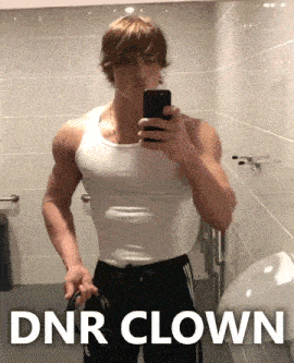 a man in a white tank top is taking a selfie in a bathroom with the words dnr clown above him
