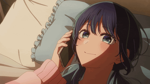 a girl laying on a bed talking on a phone