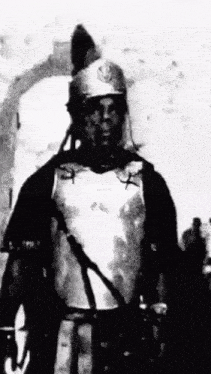 a black and white photo of a man in armor .