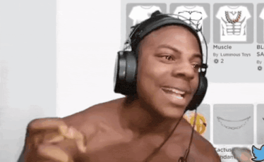 a shirtless man wearing headphones is pointing