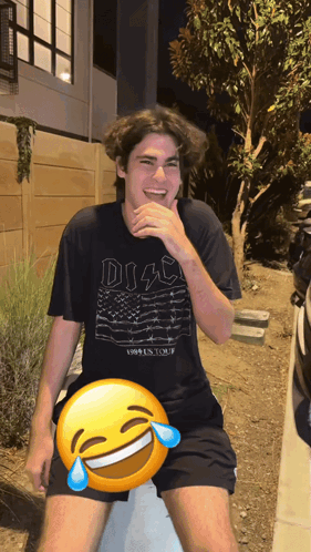 a man wearing a black disco shirt is laughing