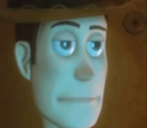 a close up of a cartoon character 's face with blue eyes and a hat .