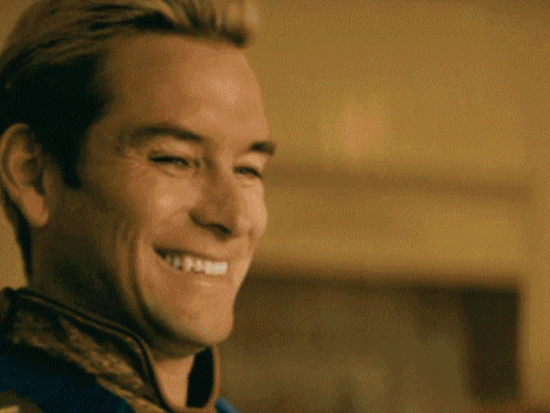 a man is smiling with his eyes closed and his mouth open