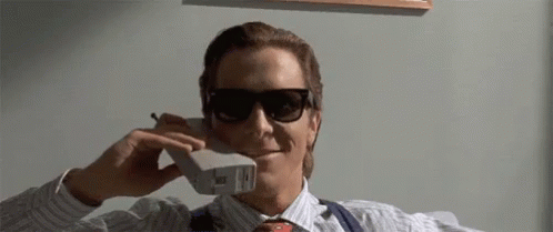 a man wearing sunglasses is talking on a cellphone