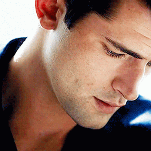 a close up of a man 's face with his eyes closed and his mouth open