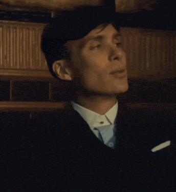 a man wearing a suit and tie is smiling