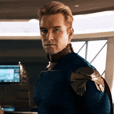 a man in a blue and gold superhero costume is standing in a room .