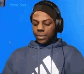 a man wearing headphones and a headband is looking at something .