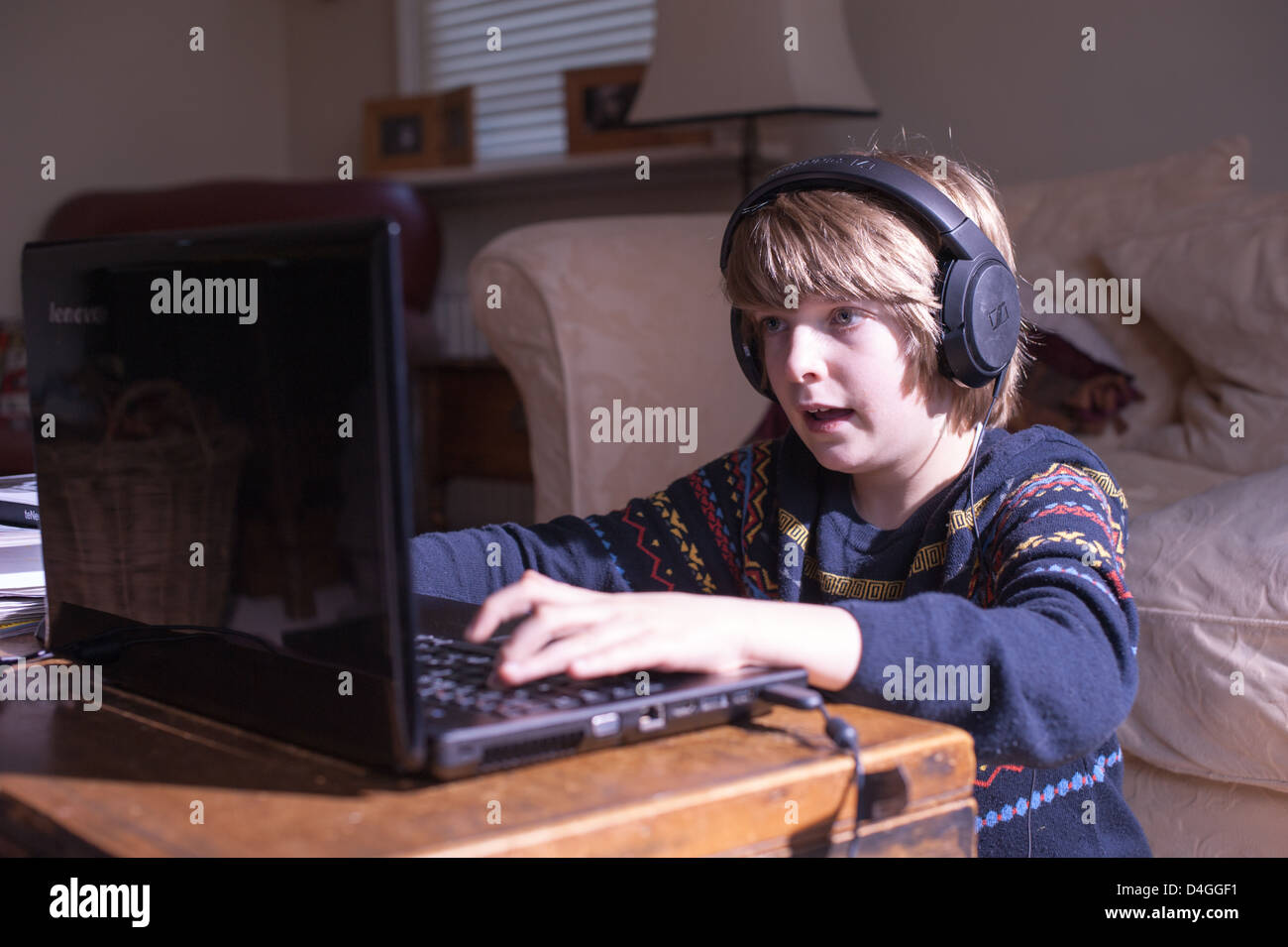 Young white boy in a living room staring at a laptop screen with headphones  on concentrating on lockdown home schooling or playing a computer game  Stock Photo - Alamy Young white boy in a living room staring at a laptop screen with headphones  on concentrating on lockdown home schooling or playing a computer game  Stock Photo - Alamy